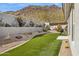 Beautiful backyard with green artificial grass, desert landscaping, and a privacy wall at 15229 E Marigold Ct, Fountain Hills, AZ 85268