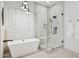 Bright bathroom featuring a soaking tub with black hardware, a glass enclosed shower, and plantation shutters at 15229 E Marigold Ct, Fountain Hills, AZ 85268