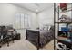 Bedroom featuring carpet flooring, a black metal storage shelf, plantation shutters, and a ceiling fan at 15229 E Marigold Ct, Fountain Hills, AZ 85268