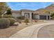 Beautiful single-story home featuring well-maintained desert landscaping and an attached two-car garage at 15229 E Marigold Ct, Fountain Hills, AZ 85268