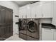 Bright laundry room featuring modern washer and dryer, sleek countertops, and ample cabinet space at 15229 E Marigold Ct, Fountain Hills, AZ 85268