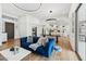 Open-concept living space with hardwood floors, a stylish blue sofa, and a view into the modern kitchen at 15229 E Marigold Ct, Fountain Hills, AZ 85268