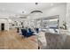 Elegant living area with hardwood floors, a blue sofa, and a view of the outdoor pool through sliding glass doors at 15229 E Marigold Ct, Fountain Hills, AZ 85268