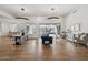 Bright living and dining area featuring hardwood floors, modern lighting, and seamless access to the outdoor pool at 15229 E Marigold Ct, Fountain Hills, AZ 85268