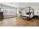 Spacious main bedroom featuring a four-poster bed, shuttered windows, and wood flooring at 15229 E Marigold Ct, Fountain Hills, AZ 85268