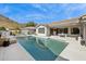 Stunning pool area with lounge seating, an outdoor dining space, and lush landscaping at 15229 E Marigold Ct, Fountain Hills, AZ 85268