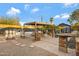 Backyard outdoor entertaining area offers gazebo with string lights, a fire pit and many places to sit and enjoy the company of friends at 1546 W Polk St, Phoenix, AZ 85007