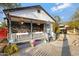 Charming home featuring a delightful front porch with vibrant flower displays and a tidy yard at 1546 W Polk St, Phoenix, AZ 85007