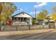 Inviting home featuring a quaint front porch decorated with colorful flowers and a lovely garden at 1546 W Polk St, Phoenix, AZ 85007