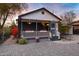 Charming home featuring a quaint front porch adorned with colorful flowers and an inviting paver walkway at 1546 W Polk St, Phoenix, AZ 85007