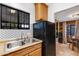 Kitchen sink with tiled backsplash, wood cabinets, and a view to the dining area at 1546 W Polk St, Phoenix, AZ 85007