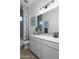 Modern bathroom featuring a large vanity, decorative mirror, and stylish fixtures at 15667 W Mercer Ln, Surprise, AZ 85379