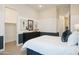 Serene bedroom with neutral walls, a patterned throw pillow, and a view into a large closet at 15667 W Mercer Ln, Surprise, AZ 85379