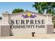 Attractive SURPRISE COMMUNITY PARK entrance sign surrounded by desert landscaping to welcome residents and guests at 15667 W Mercer Ln, Surprise, AZ 85379