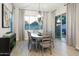 Stylish dining area featuring a modern chandelier, natural light, and slider to outdoor living space at 15667 W Mercer Ln, Surprise, AZ 85379