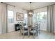 Cozy dining area with stylish chandelier, neutral tones, and an abundance of natural light at 15667 W Mercer Ln, Surprise, AZ 85379