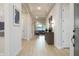 Bright hallway with wood floors, and decorative accents leading to an open-concept living area at 15667 W Mercer Ln, Surprise, AZ 85379