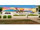 Exterior view of the Surprise Regional Library with its mural and clock tower at 15667 W Mercer Ln, Surprise, AZ 85379