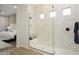 Contemporary bathroom featuring a frameless glass shower with designer tile and modern fixtures at 15667 W Mercer Ln, Surprise, AZ 85379