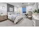 Beautiful bedroom features patterned accent wall, large bed, decorative lighting, and ample natural light at 15683 W Mercer Ln, Surprise, AZ 85379