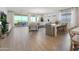 Bright living room featuring light wood floors, large sliding glass doors, and stylish modern furniture at 15683 W Mercer Ln, Surprise, AZ 85379