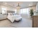 Elegant main bedroom with a chandelier, plush bedding, and serene decor at 15683 W Mercer Ln, Surprise, AZ 85379