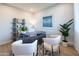 Stylish home office showcasing blue accent wall, modern shelving unit, and comfortable seating at 15683 W Mercer Ln, Surprise, AZ 85379