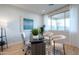 Bright home office featuring a modern desk setup, accent wall, and large window for natural light at 15683 W Mercer Ln, Surprise, AZ 85379