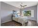 Bedroom featuring a ceiling fan, shuttered windows, decorative bedding and neutral paint at 15701 W Huron Dr, Sun City West, AZ 85375