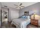 Cozy bedroom features a ceiling fan, closet, and wood-look floors for a comfortable, modern living space at 15701 W Huron Dr, Sun City West, AZ 85375