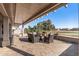 Relaxing covered patio featuring comfortable seating and views of the lush desert landscape at 15701 W Huron Dr, Sun City West, AZ 85375