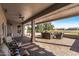 Inviting covered patio featuring comfortable seating and views of the lush golf course and desert landscape at 15701 W Huron Dr, Sun City West, AZ 85375