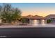 Single-story home featuring a tile roof, three-car garage, and desert landscaping at 15701 W Huron Dr, Sun City West, AZ 85375