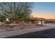 Stunning exterior of a home featuring lush desert landscaping, well-maintained lawn, and a three-car garage at 15701 W Huron Dr, Sun City West, AZ 85375