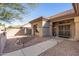 Welcoming front entrance with a security door, desert landscaping, and a sidewalk at 15701 W Huron Dr, Sun City West, AZ 85375