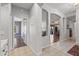 Hallway with tile and wood flooring, featuring archways and leading into various rooms of the house at 15701 W Huron Dr, Sun City West, AZ 85375