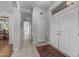 Bright hallway featuring tile floors, neutral walls, and access to the front entrance at 15701 W Huron Dr, Sun City West, AZ 85375