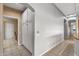 Hallway with tile floors leads to a room with a desk and cabinets, offering extra storage space at 15701 W Huron Dr, Sun City West, AZ 85375