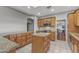 Well-lit kitchen featuring wood cabinets, granite countertops, and stainless steel appliances at 15701 W Huron Dr, Sun City West, AZ 85375