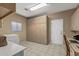 Laundry room equipped with a washer, dryer, storage cabinets, and a desk at 15701 W Huron Dr, Sun City West, AZ 85375