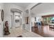 Open-concept living room with tile flooring, grand arches, and seamless flow into the living spaces at 15701 W Huron Dr, Sun City West, AZ 85375