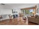 Comfortable living room with hardwood floors, a window with plantation shutters, and neutral decor at 15701 W Huron Dr, Sun City West, AZ 85375