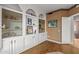 Living room featuring built-in cabinets for storage, hardwood floors, and light neutral paint at 15701 W Huron Dr, Sun City West, AZ 85375