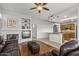 Cozy living room with a fireplace, built-in shelving, and hardwood floors at 15701 W Huron Dr, Sun City West, AZ 85375