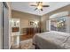 Relaxing main bedroom featuring a ceiling fan, neutral paint, hard floors, and access to the ensuite bathroom at 15701 W Huron Dr, Sun City West, AZ 85375