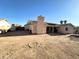 Wide backyard view showcasing a brick patio, a chimney, and a large dirt area at 1636 E Marigold St, Casa Grande, AZ 85122