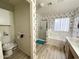 Bright bathroom with a shower, soaking tub, and floral wallpaper, offering a relaxing space at 1636 E Marigold St, Casa Grande, AZ 85122