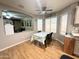 Bright dining room features laminate wood flooring, a modern ceiling fan, and views to the kitchen and backyard at 1636 E Marigold St, Casa Grande, AZ 85122