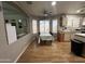 Bright dining room features laminate wood flooring and a modern ceiling fan, conveniently located adjacent to the kitchen at 1636 E Marigold St, Casa Grande, AZ 85122