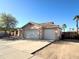 This exterior shot showcases the home's three-car garage and desert-style landscaping at 1636 E Marigold St, Casa Grande, AZ 85122